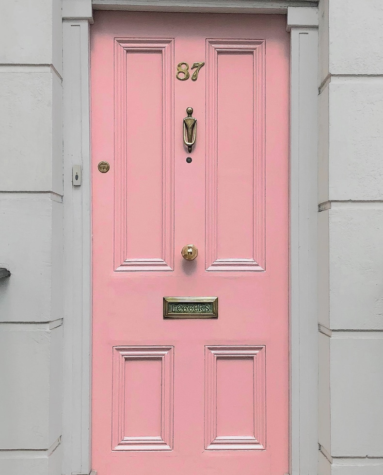 pink color front door gray house