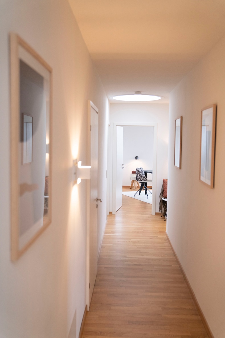 visually widen a narrow hallway by installing lights