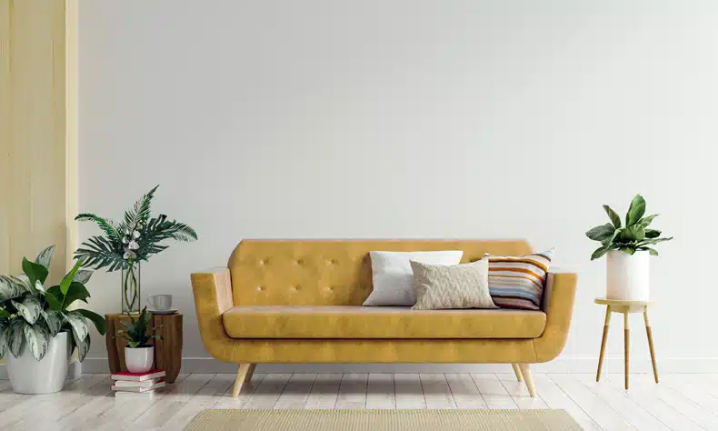 grey wall with mustard sofa