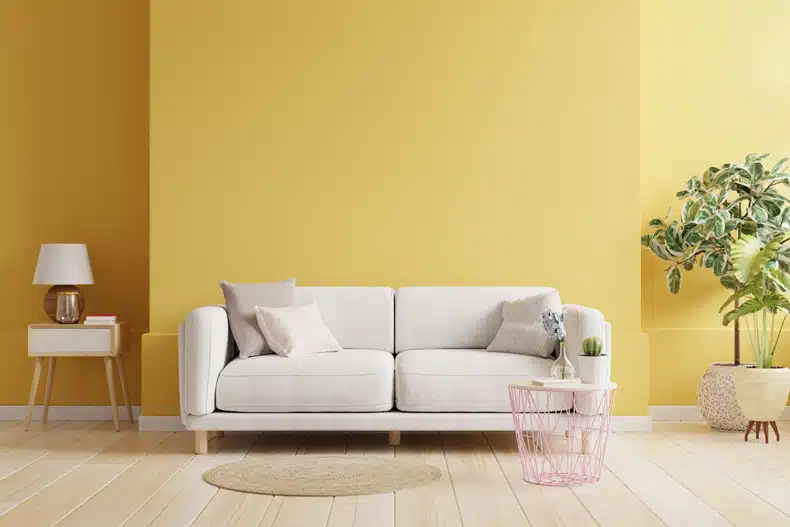 mustard living room wall with beige and pink furnitures