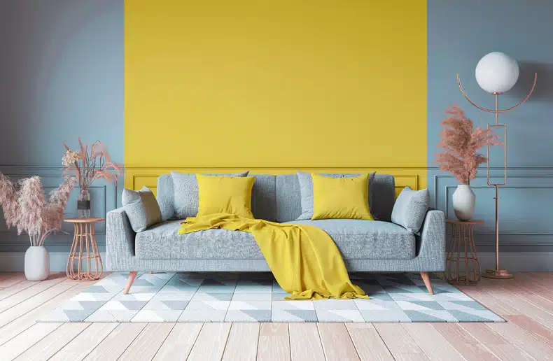 living room with teal and mustard wall and rug 