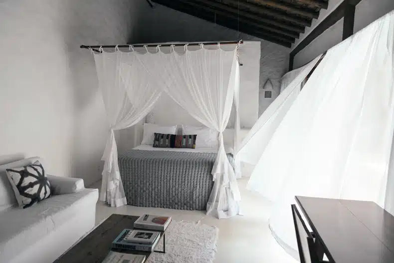 minimalist boho bedroom with white wall and empty space