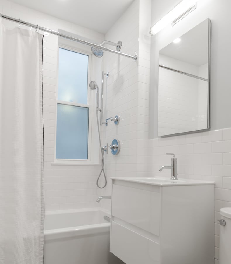 white floor to ceiling tiles scandi bathroom