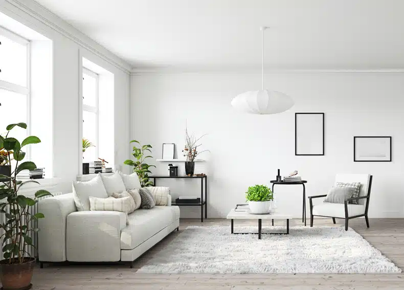 all white minimalist scandinavian living room with some plants 
