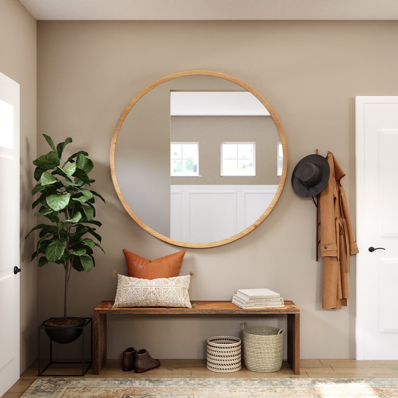 small foyer with big round mirror