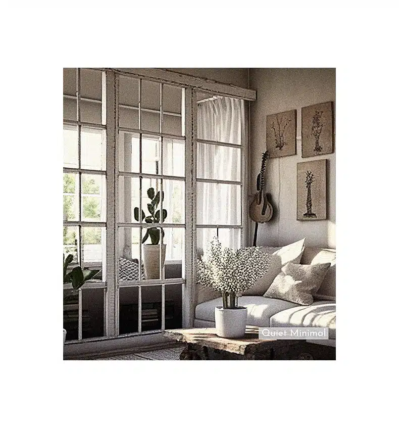 A living room with a white couch, potted plant, and repurposed vintage windows as home decor.