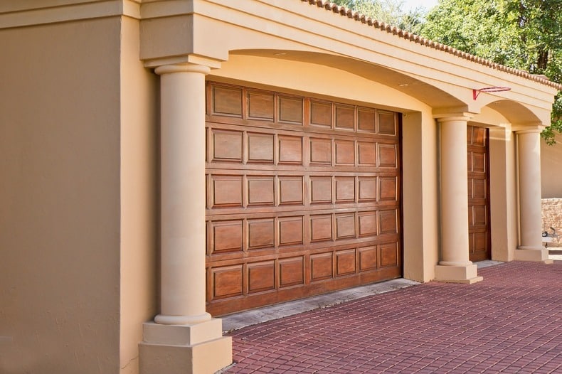 An ideal two-car garage should be at least 20 feet wide and 22 feet deep, with 8 to 9 feet high ceilings to fit two vehicles comfortably, and additional space for storage or workshop area
