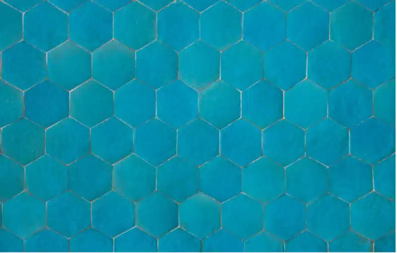 Boho chic teal hexagon tile backsplash adds a unique and stylish pop of color to the kitchen.