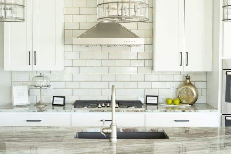 elegant and vintage antique old copper subway tile backsplash in a small kitchen