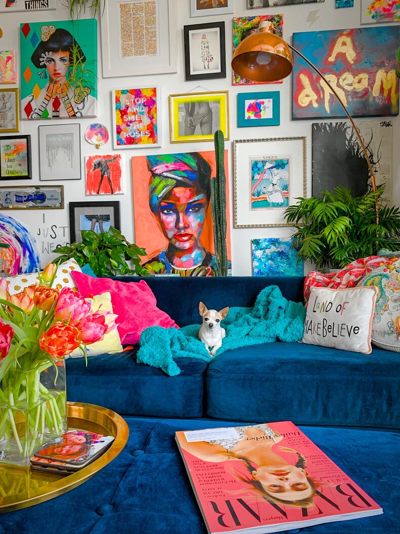 A vibrant and bold maximalist room filled with a mix of patterns, textures, shapes and colors.