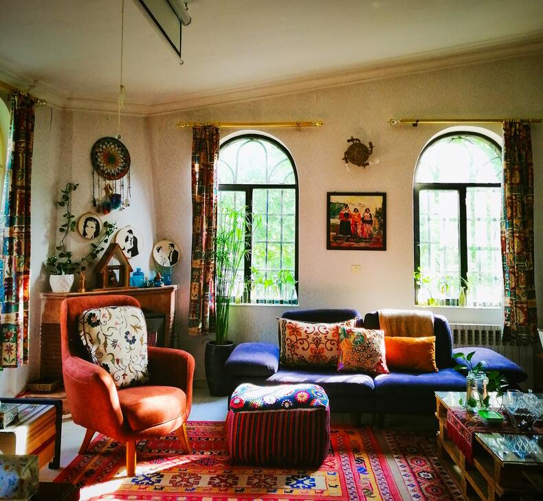 A vibrant maximalist living room with colorful patterns and textures creating a unique style