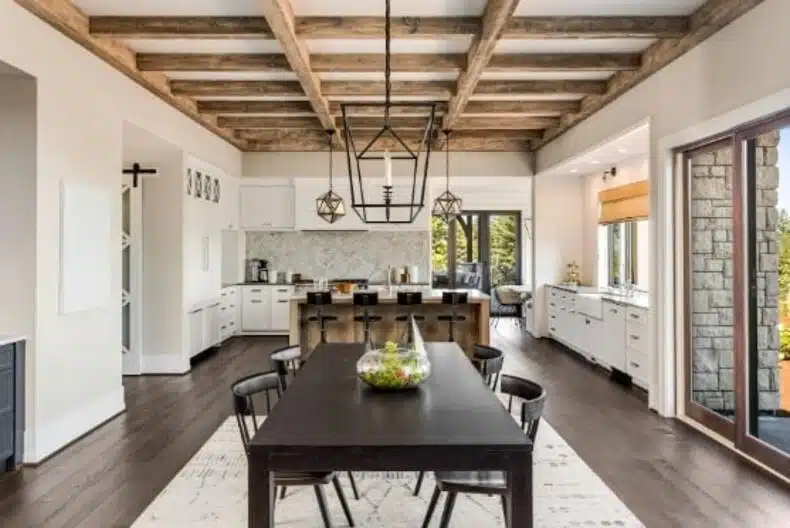 A coffered ceiling with a false wooden beam and curved brackets adds texture and visual interest to the room