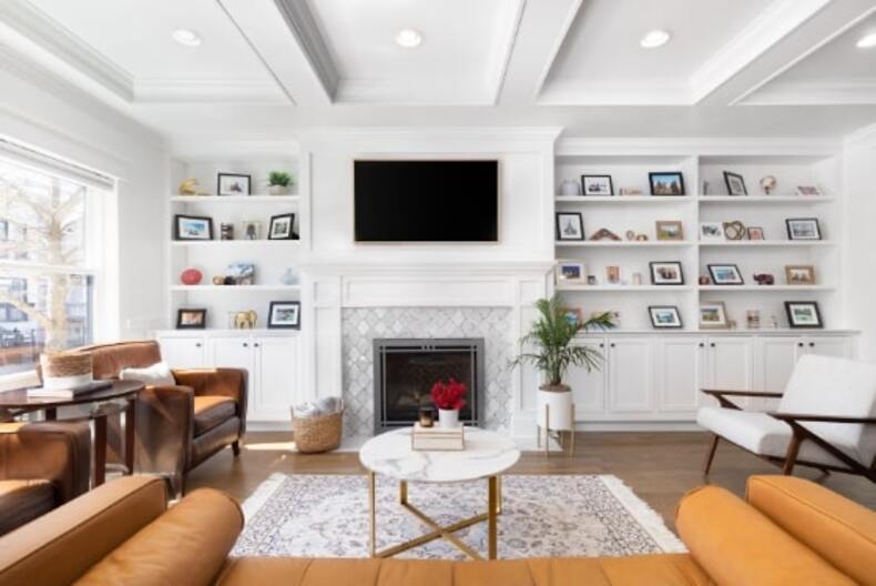 A coffered ceiling with wooden beams and recessed panels adds elegance and depth to a room