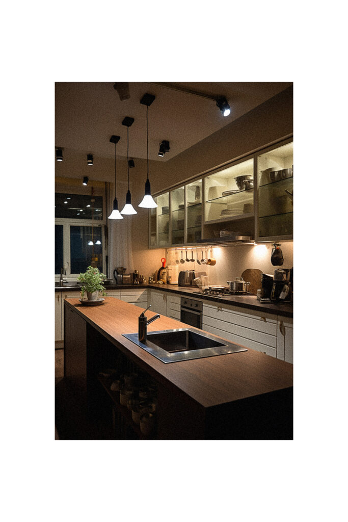 A kitchen is creatively lit up at night.