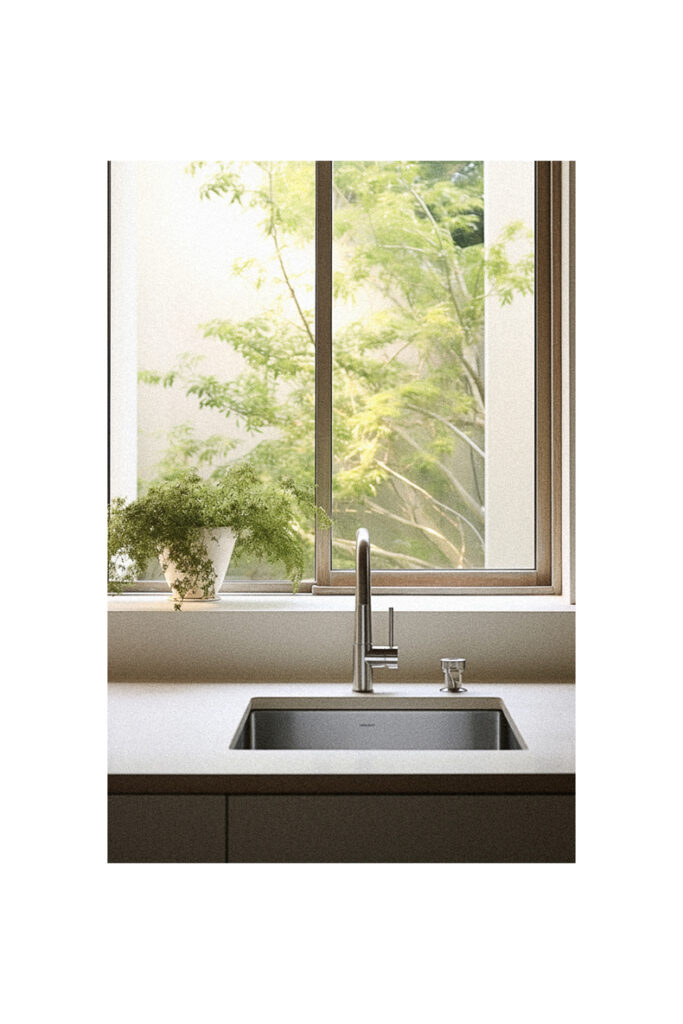 A kitchen sink in front of a window showcasing innovative kitchen window ideas.