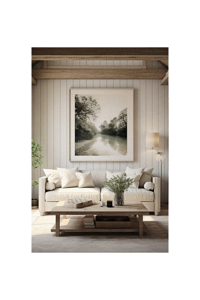 A modern living room with a large framed picture of a river.