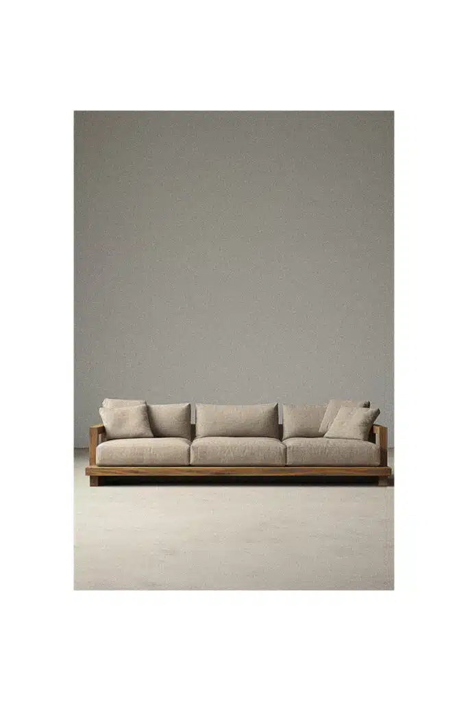 A simple sofa in a room with a gray background.