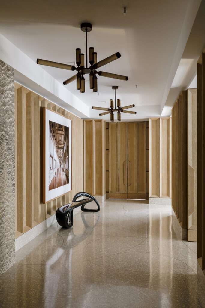 A hallway with a ceiling fan.