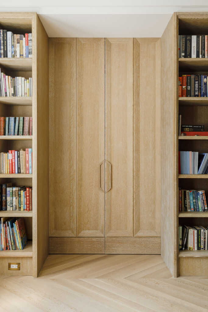 A room with bookshelves and a door.