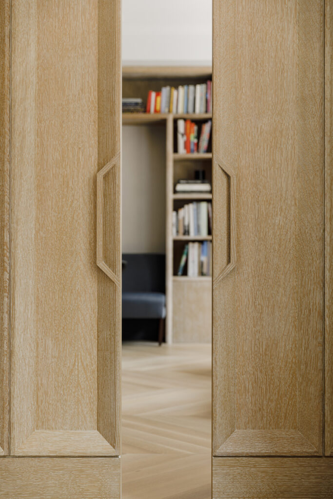 A wooden door in a living room.