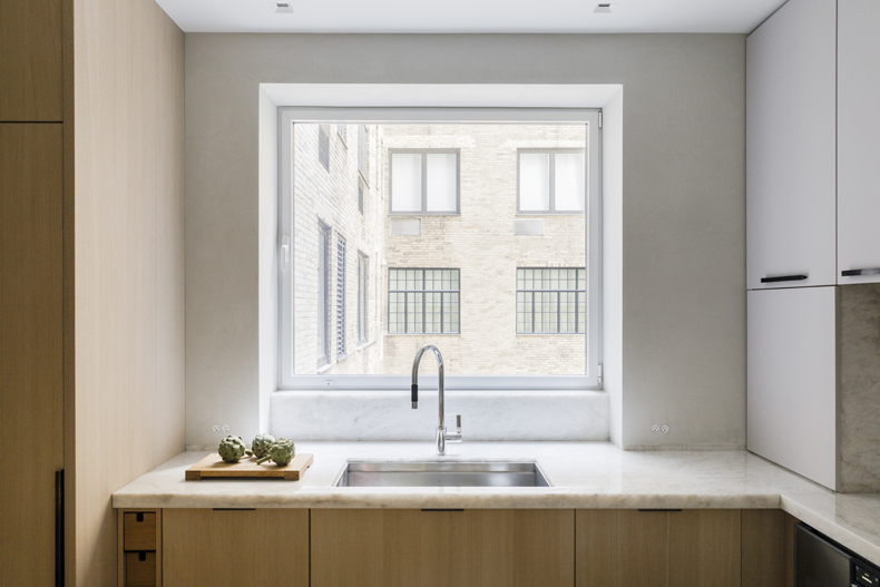A kitchen with a sink and a window.