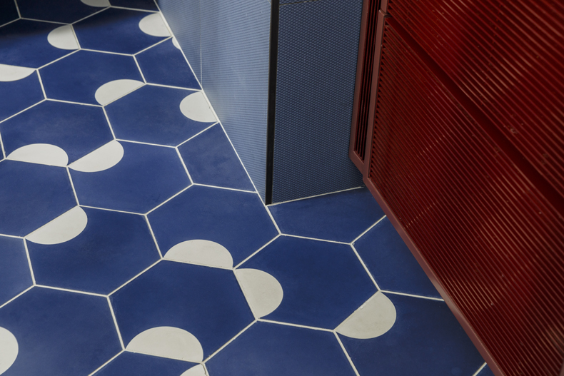 A blue and white tiled floor in a bathroom.