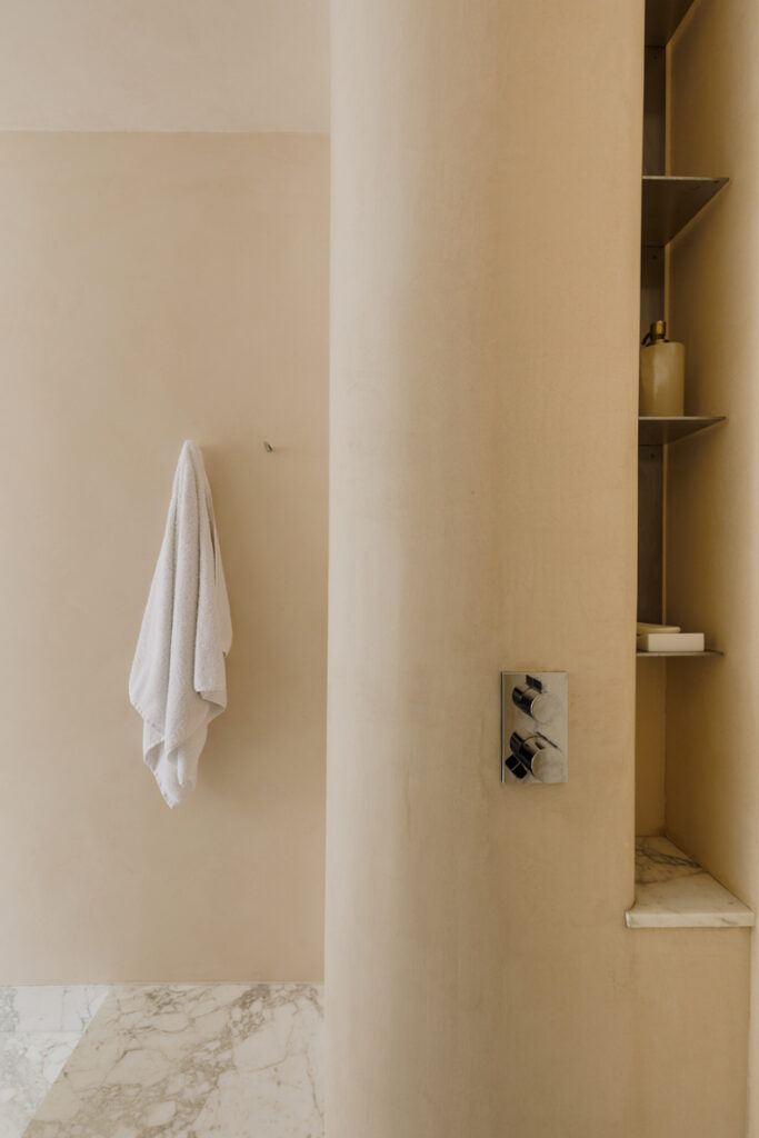 A bathroom with a towel hanging on the wall.