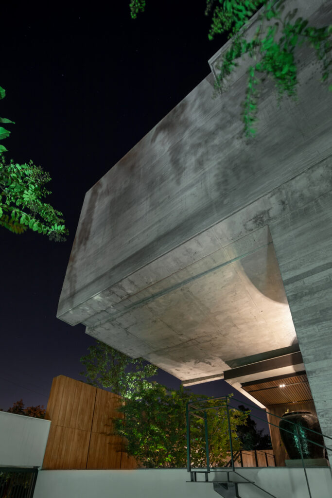 A modern concrete house at night.
