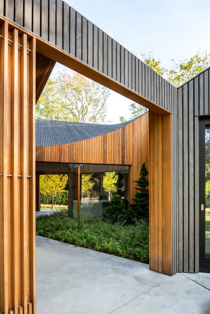 The entrance to a modern house with wooden slats.