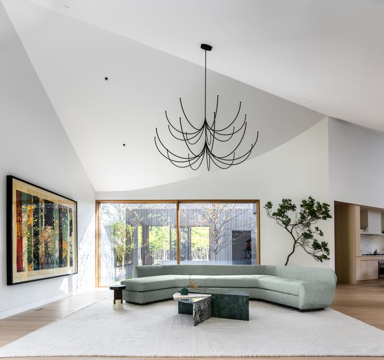 A modern living room with a chandelier.