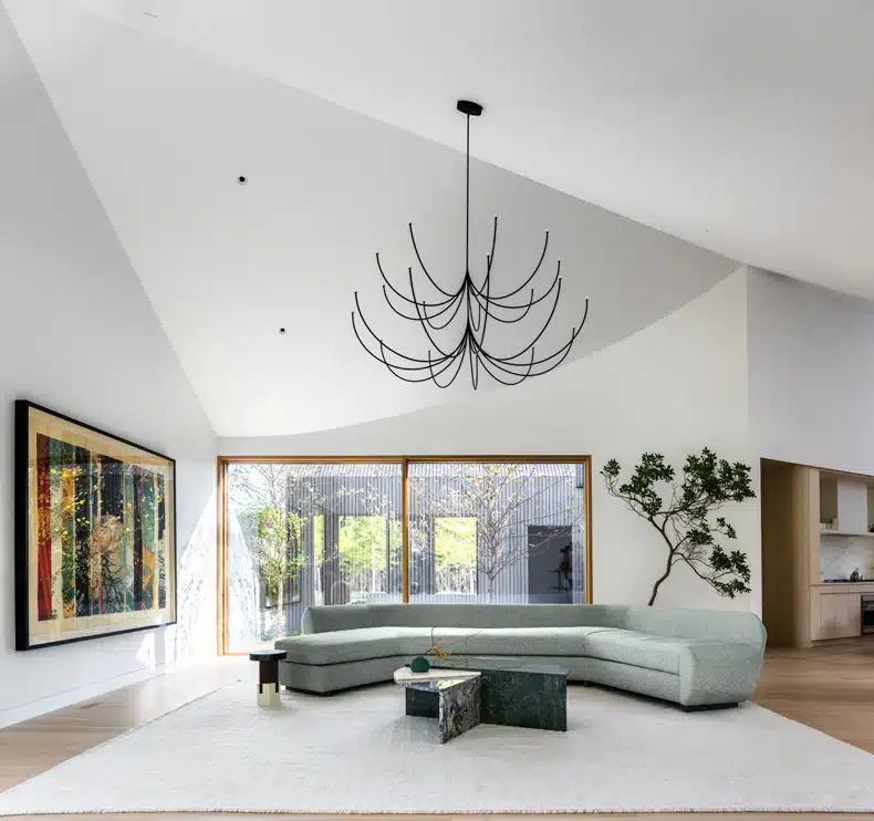 A modern living room with a chandelier.