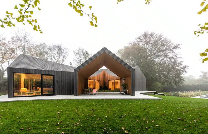 A modern house in the middle of the woods.