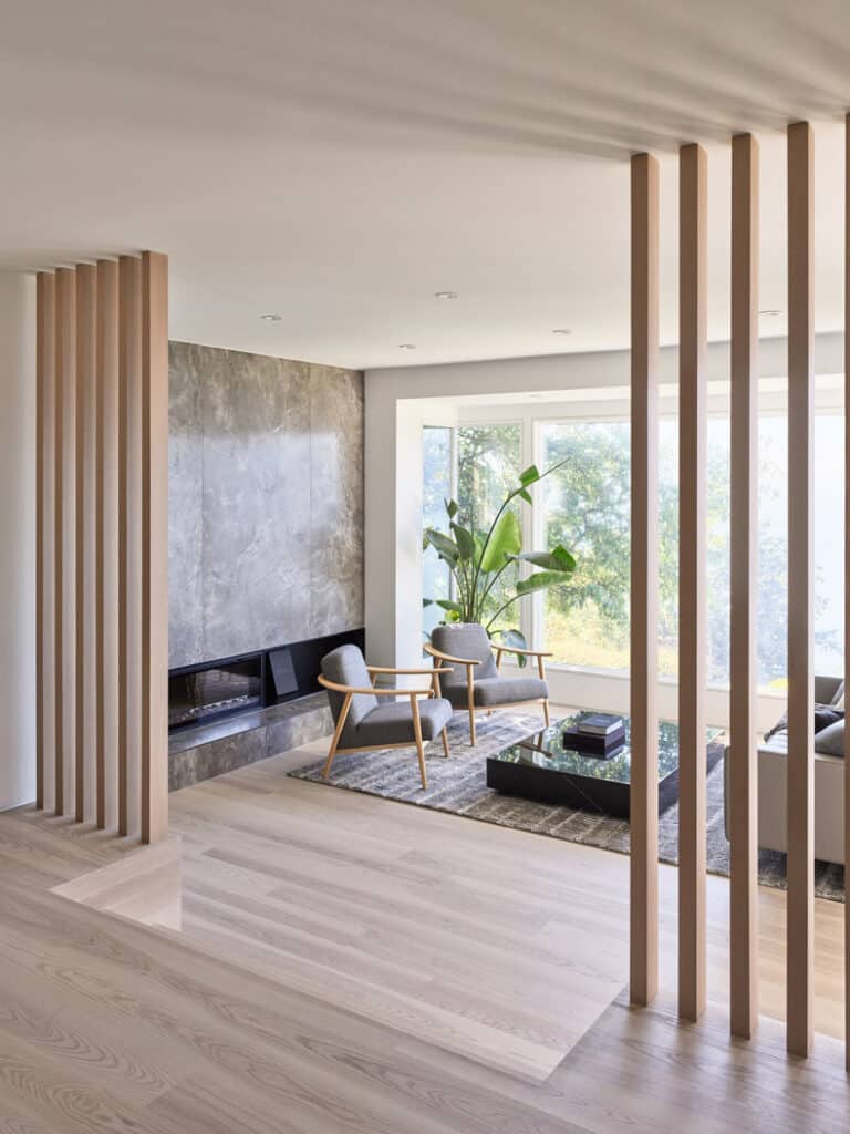 A modern living room with wooden dividers, fashioned by BLA Design Group.