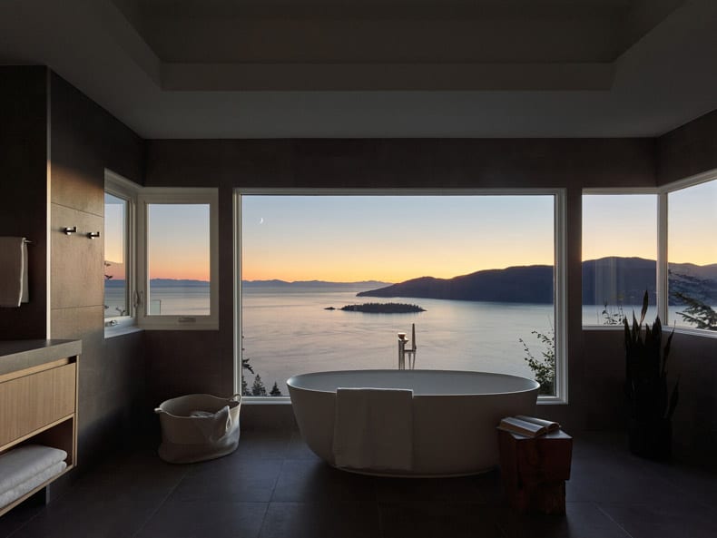 Fashioned by BLA Design Group: A bathroom with a view of the ocean and mountains.