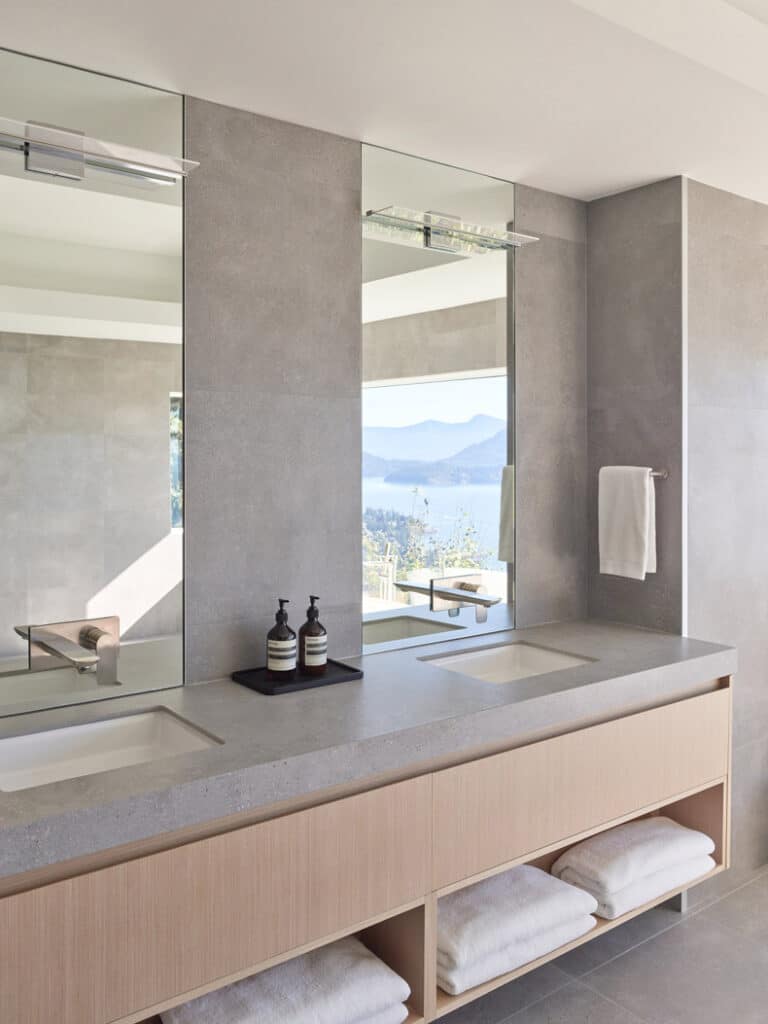 A bathroom with two sinks and a mirror fashioned by BLA Design Group.