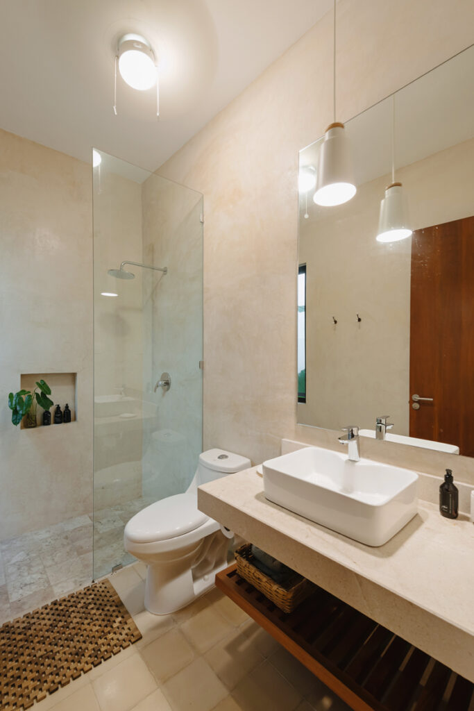 A bathroom with a sink, toilet and shower.
