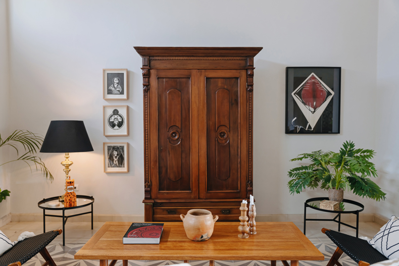 A wooden armoire in a living room.