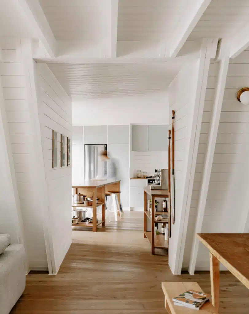 A chalet-inspired living room with a wooden floor and white walls.