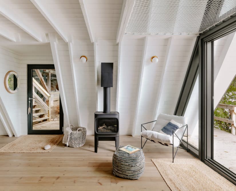A wood-burning stove in a chalet-style living room.