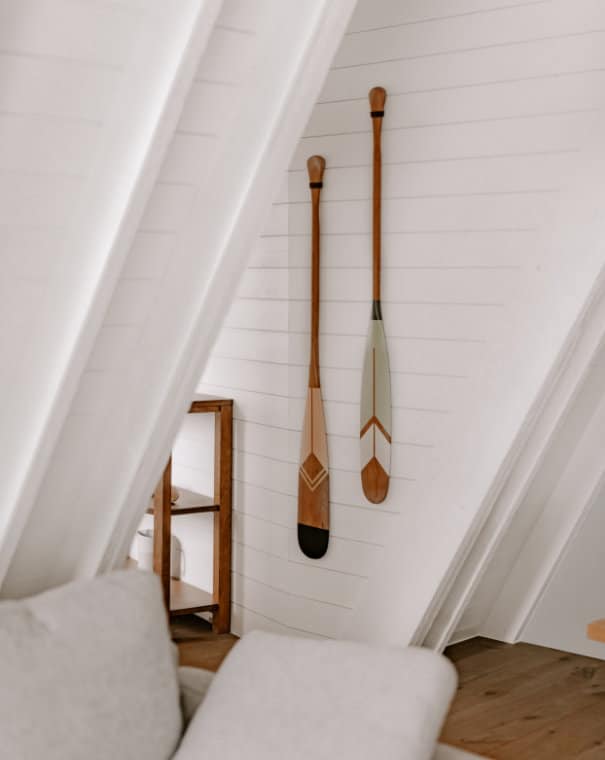 Wooden paddles hanging in a chalet attic.