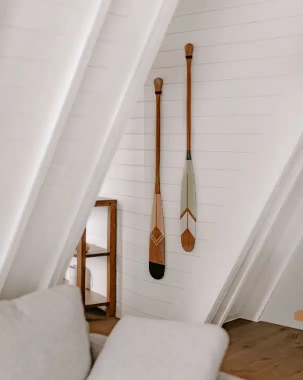 Wooden paddles hanging in a chalet attic.