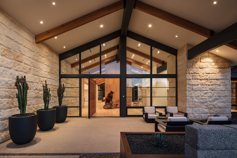 A modern entrance to a home with large windows.