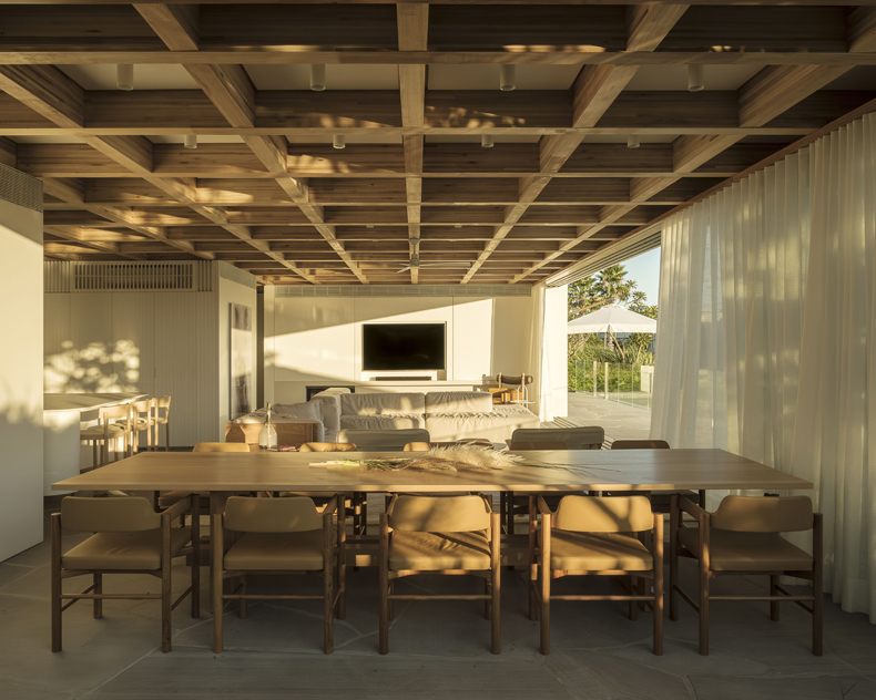 A dining room with a wooden ceiling.