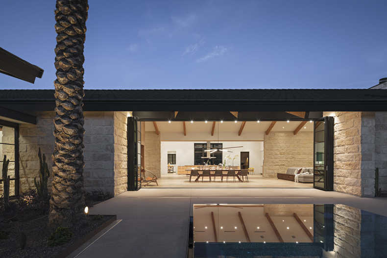 A modern home with a pool and patio.
