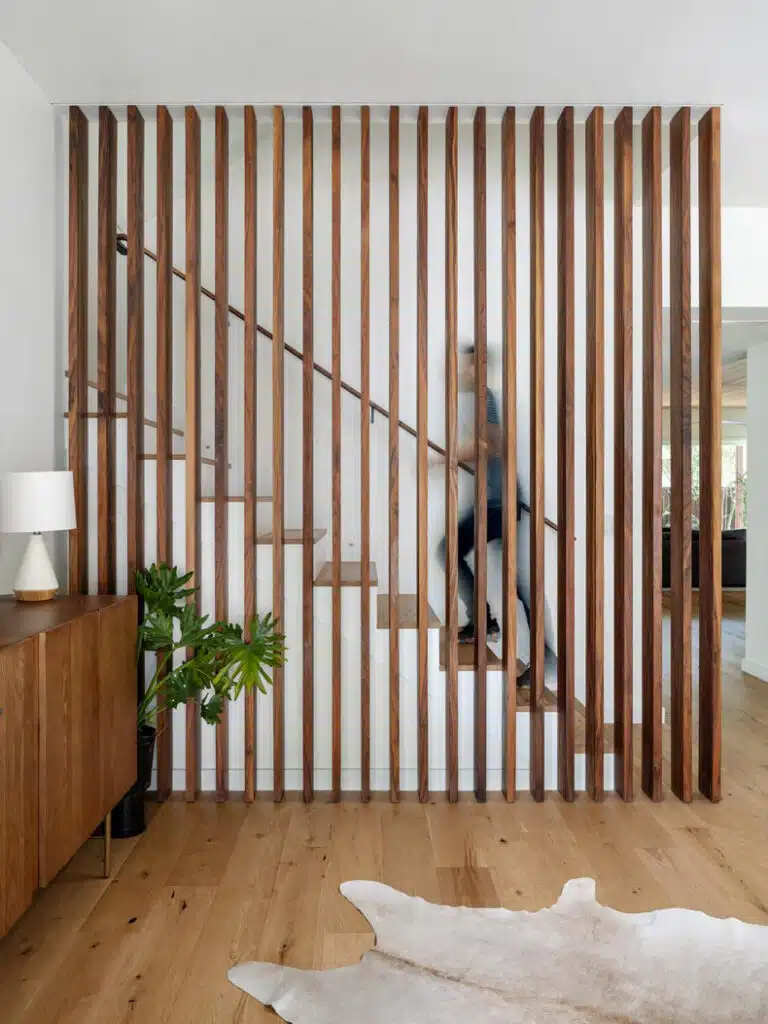 A modern home with wooden slats and a cowhide rug.