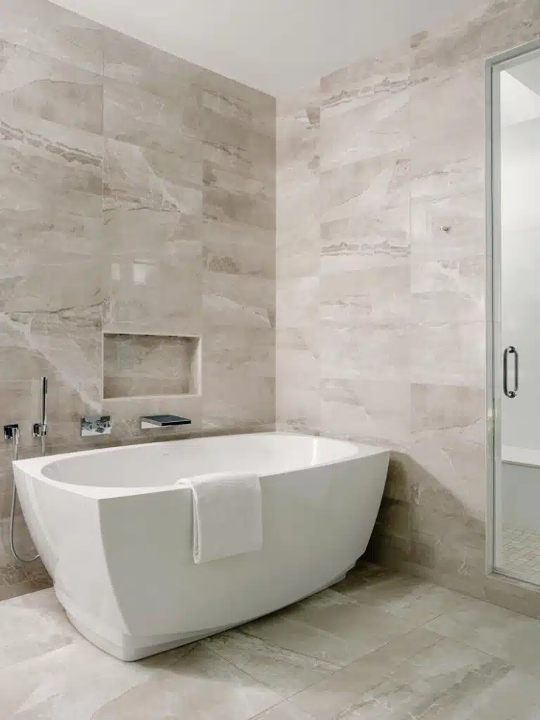 A bathroom with a white tub and glass shower.