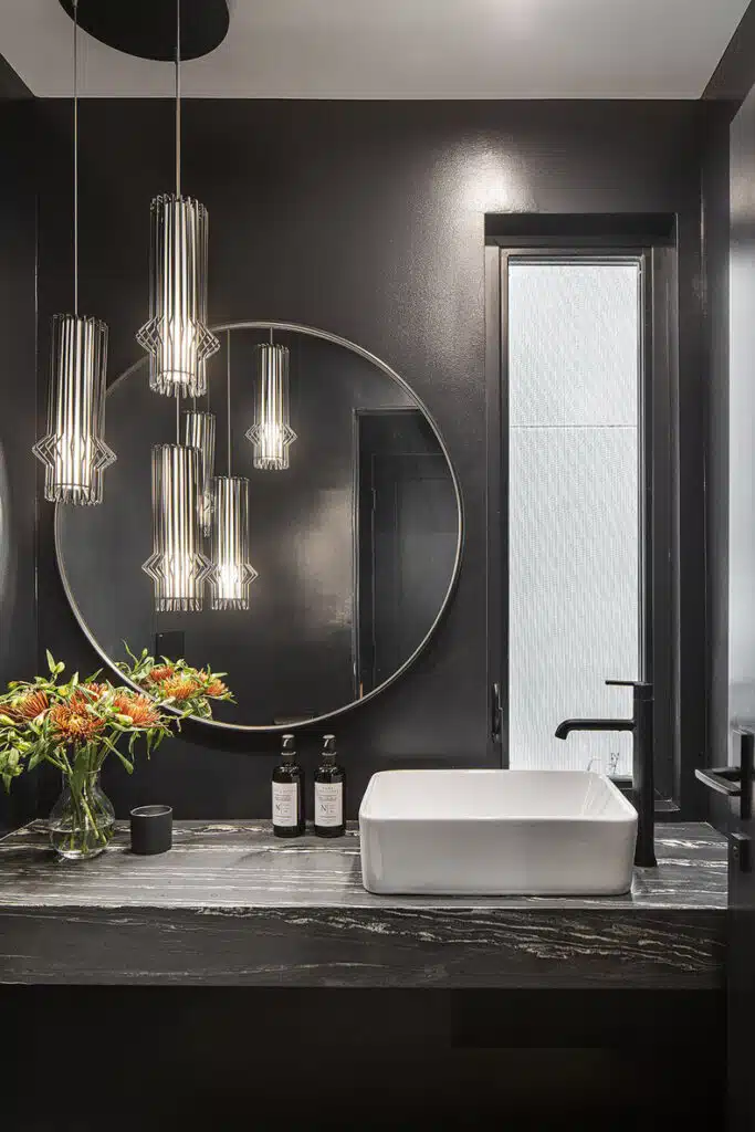 A bathroom with black walls and a large mirror.