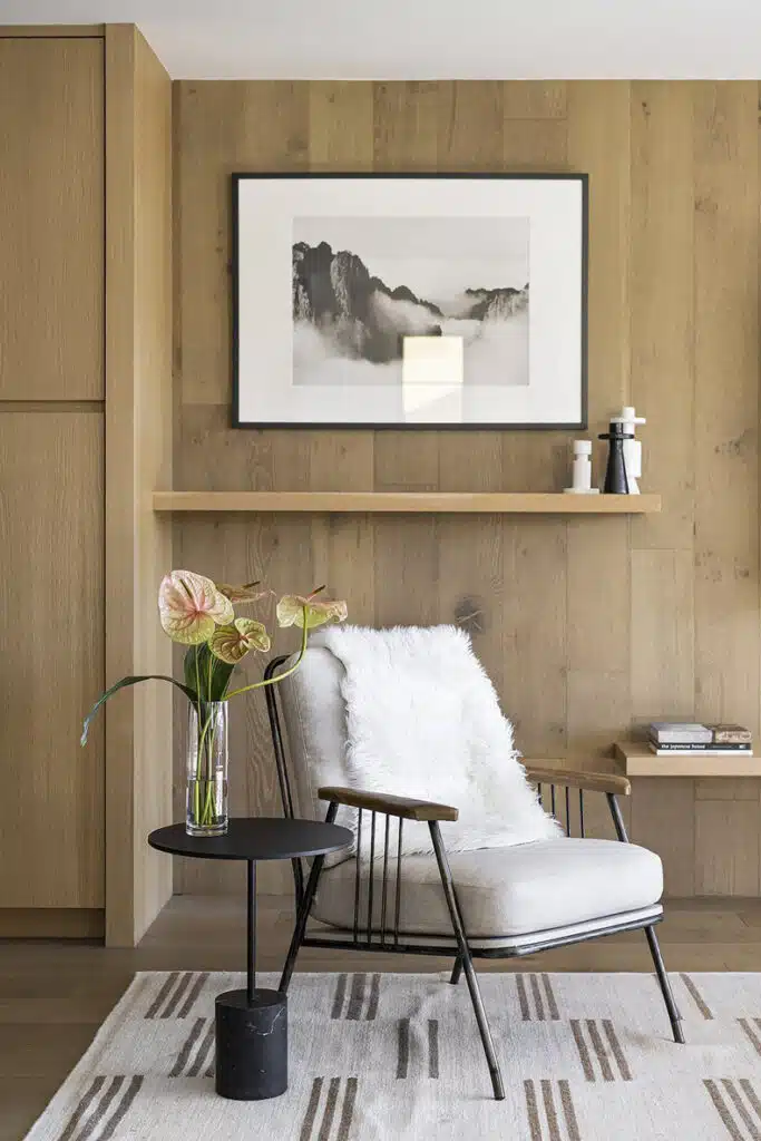 A living room with wooden walls and a chair.