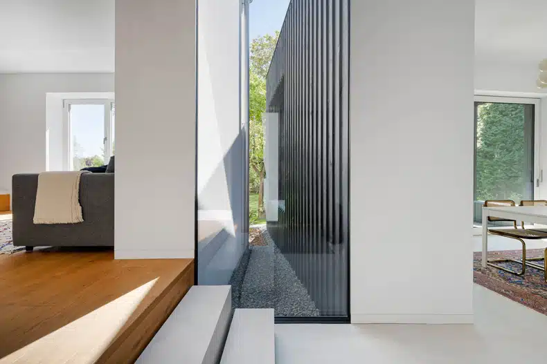 A modern living room with a glass wall.