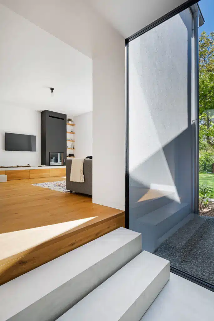 A modern living room with a glass wall.